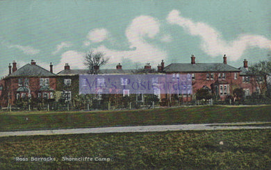 Vintage postcard of a row of houses with a banner in the center, set against a blue sky.