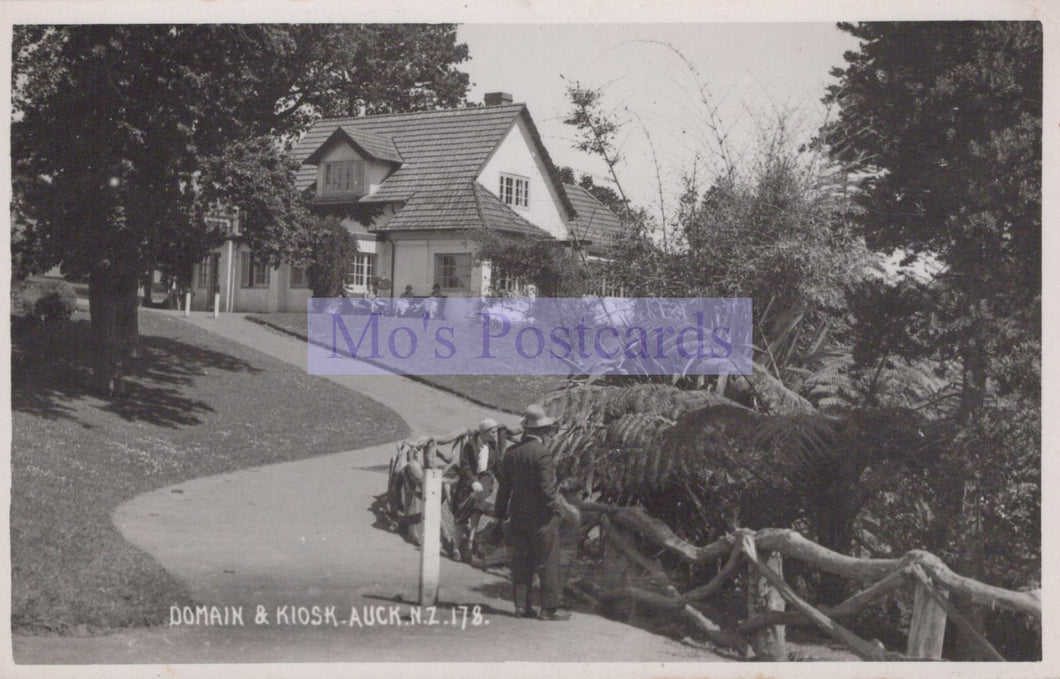Vintage black and white photo of a house with a person walking a horse, labeled 'Mo's Postcards'.