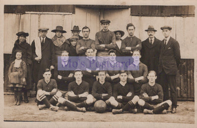 Vintage black and white photo of a soccer team with a blurred text overlay