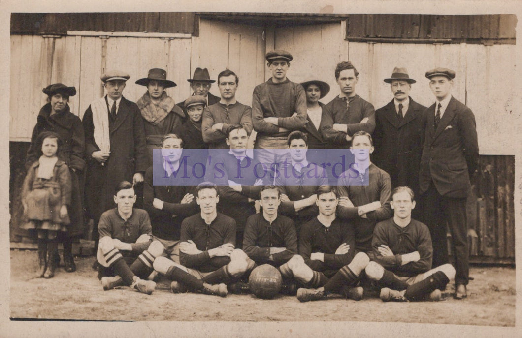 Vintage black and white photo of a soccer team with a blurred text overlay