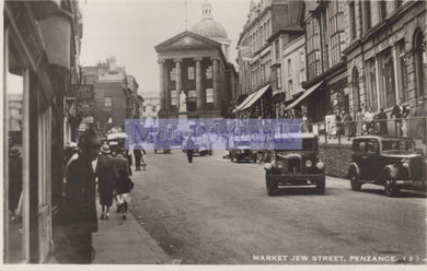 Vintage black and white photo of Market Jew Street, Penzance with people and cars.
