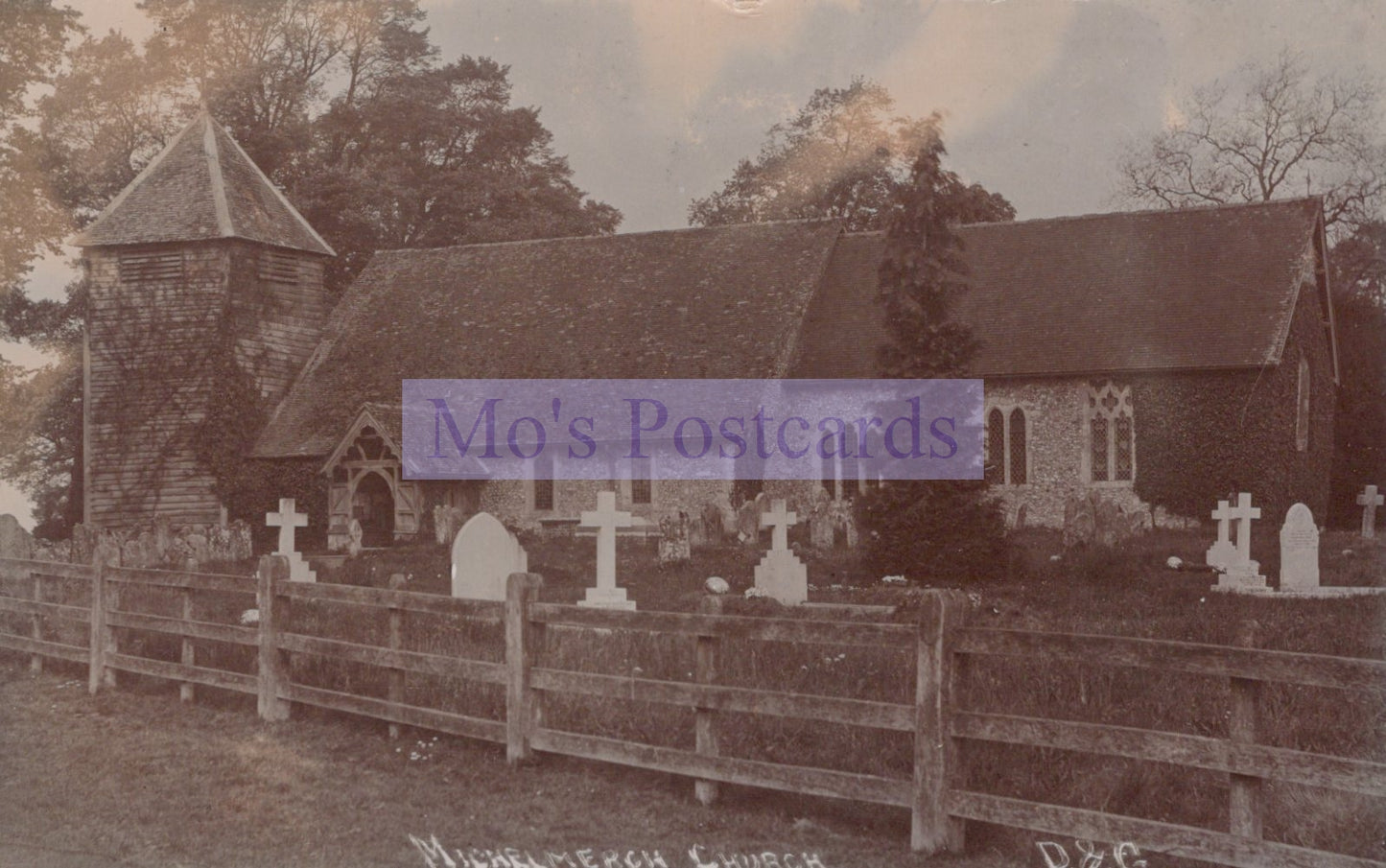 Vintage photograph of a church with a graveyard and wooden fence.