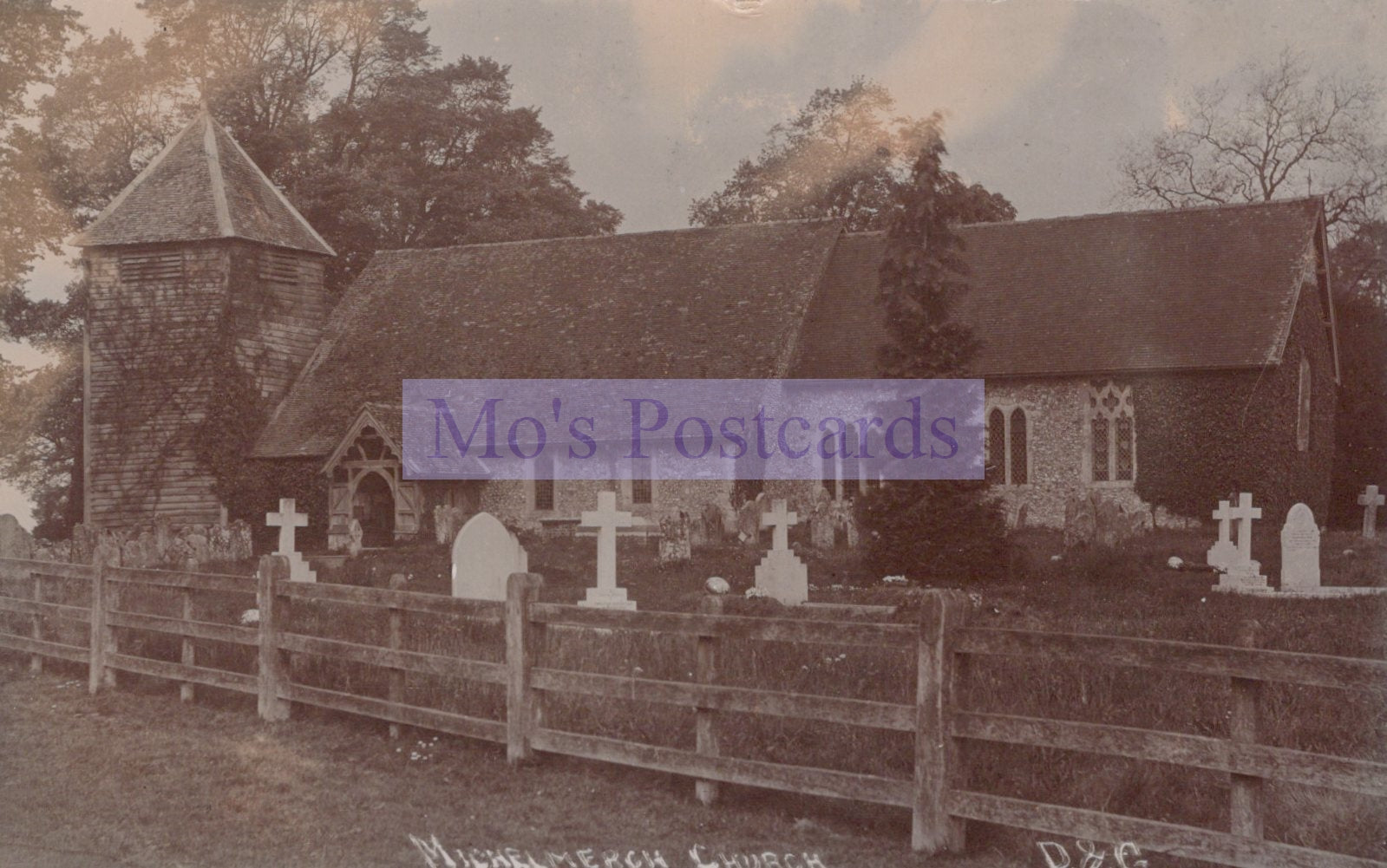 Vintage photograph of a church with a graveyard and wooden fence.