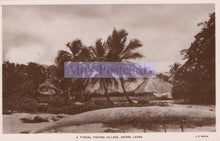 Load image into Gallery viewer, Vintage sepia-toned postcard of a typical fishing village in Sierra Leone with palm trees and huts.
