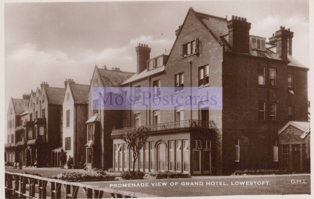 Vintage black and white postcard of a promenade view of the Grand Hotel in Lowestoft.