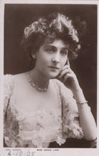 Load image into Gallery viewer, Vintage photograph of a woman in formal attire with jewelry, against a dark background.
