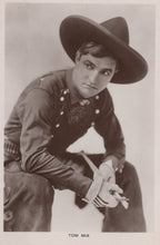 Load image into Gallery viewer, Vintage black and white photo of a person in military uniform with a hat, holding a gun.
