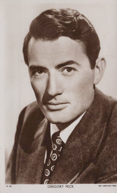 Black and white portrait of Gregory Peck with a suit and tie.