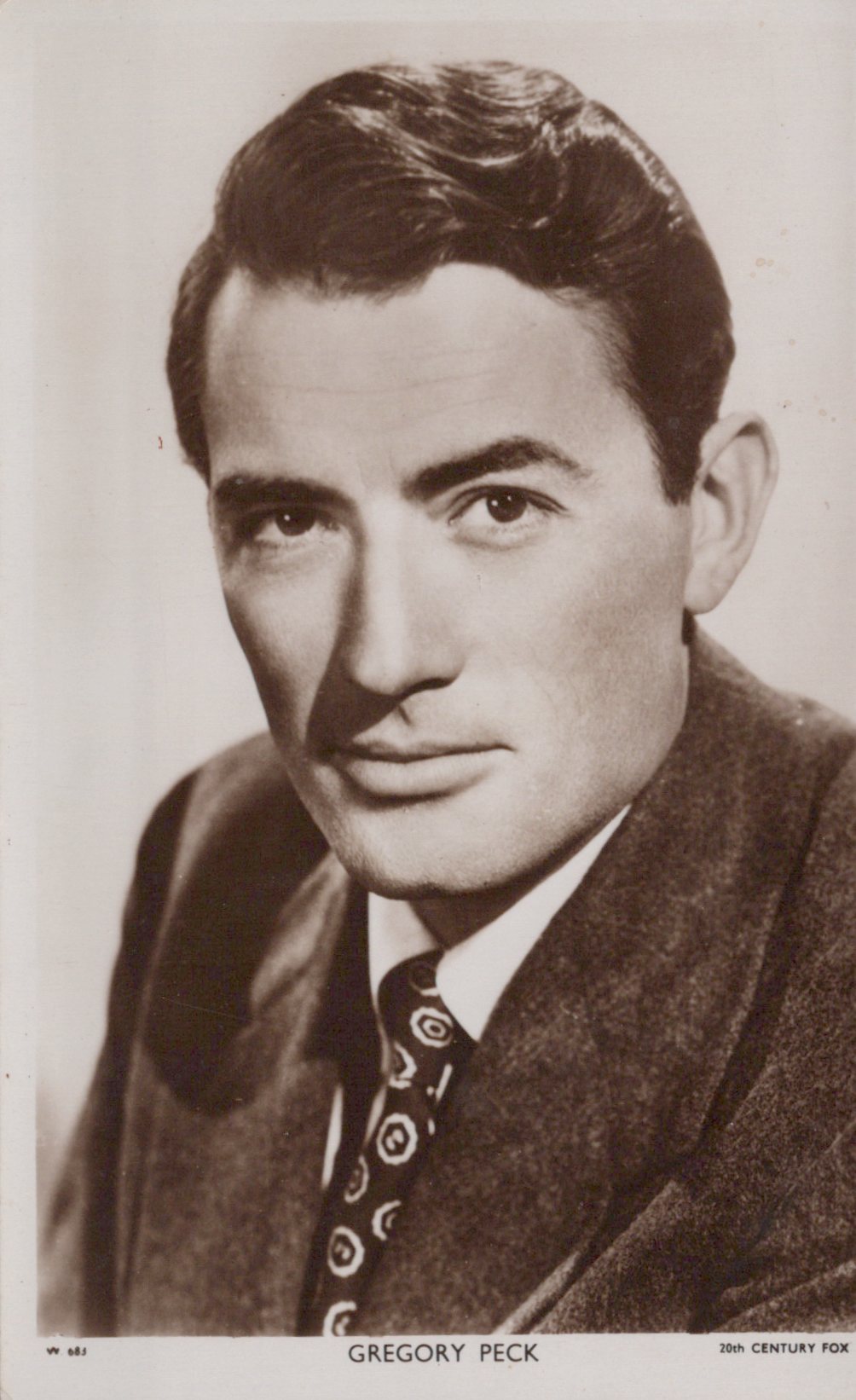 Black and white portrait of Gregory Peck with a suit and tie.