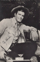 Load image into Gallery viewer, Black and white photo of a person in cowboy attire with a signature on a card.
