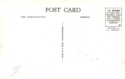 Back of a postcard with text and a signature