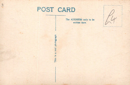 Vintage postcard with text and a signature on a beige background