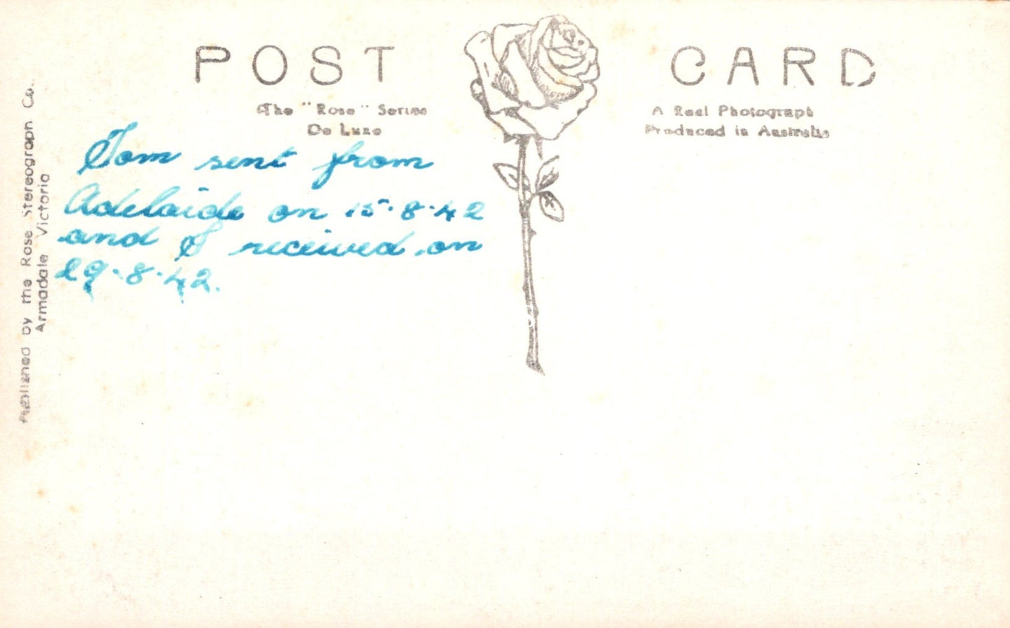 Vintage postcard with a rose illustration and handwritten text on a light background