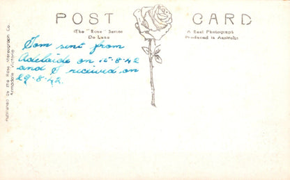 Vintage postcard with a rose illustration and handwritten text on a light background