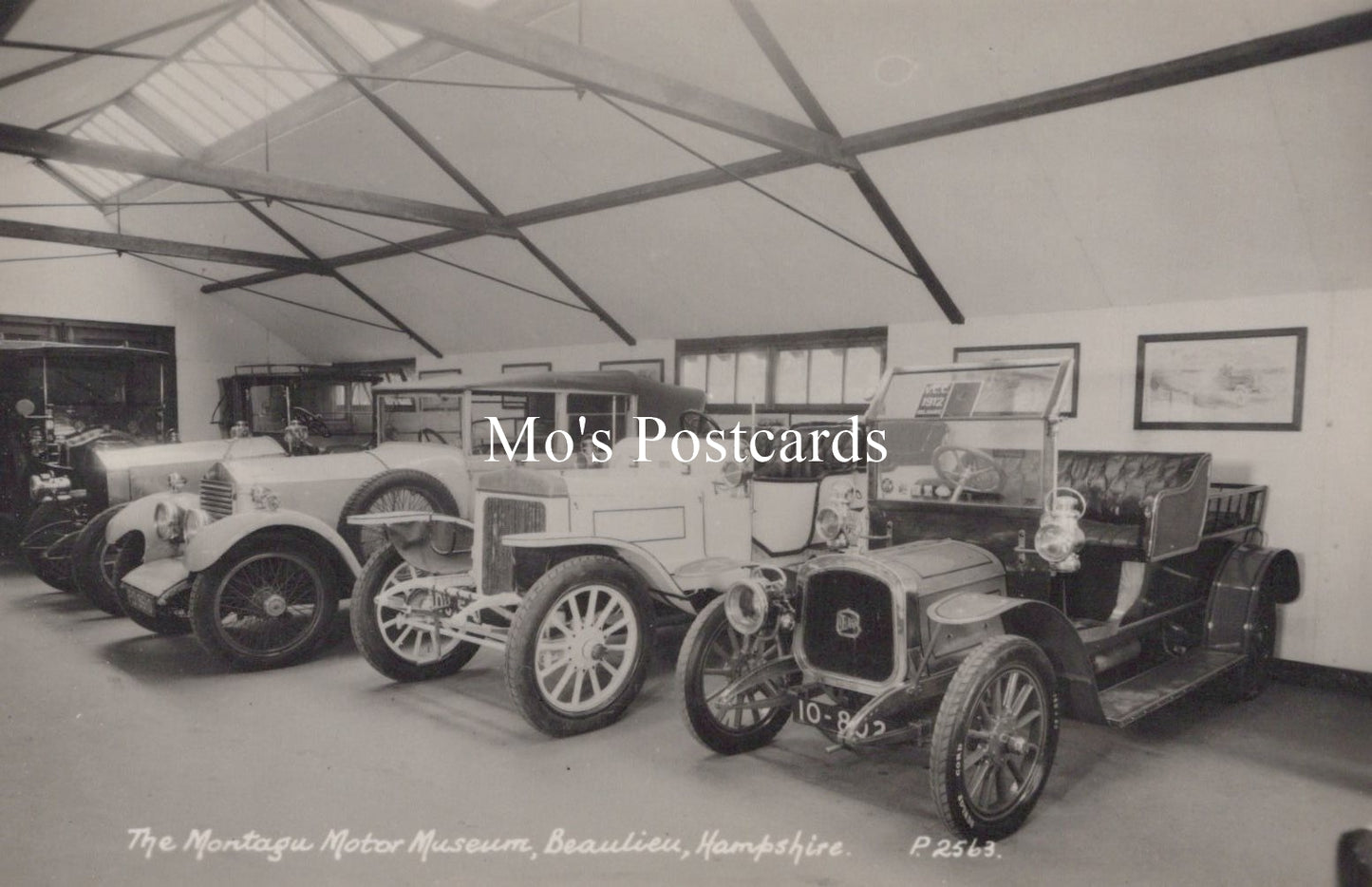 Vintage cars inside a garage at The Montagu Motor Museum, Beaulieu, Hampshire.
