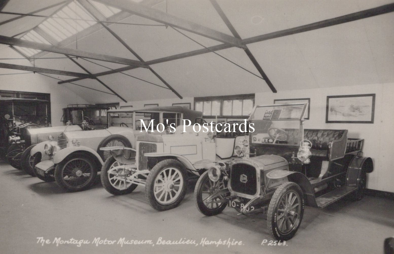 Vintage cars inside a garage at The Montagu Motor Museum, Beaulieu, Hampshire.