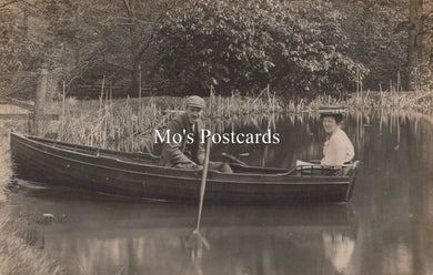 Two people in a boat on a calm body of water with 'Mo's Postcards' text overlay.