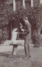 Load image into Gallery viewer, Vintage black and white photo of a man and dog in a garden setting 
