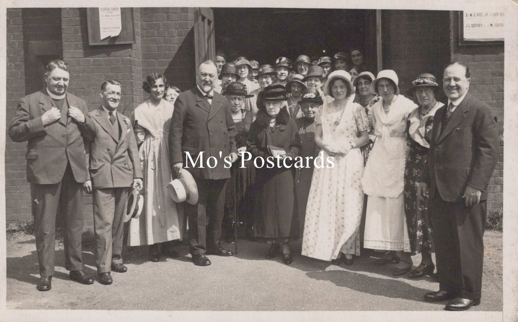 Vintage black and white photo of a group of people posing outdoors 