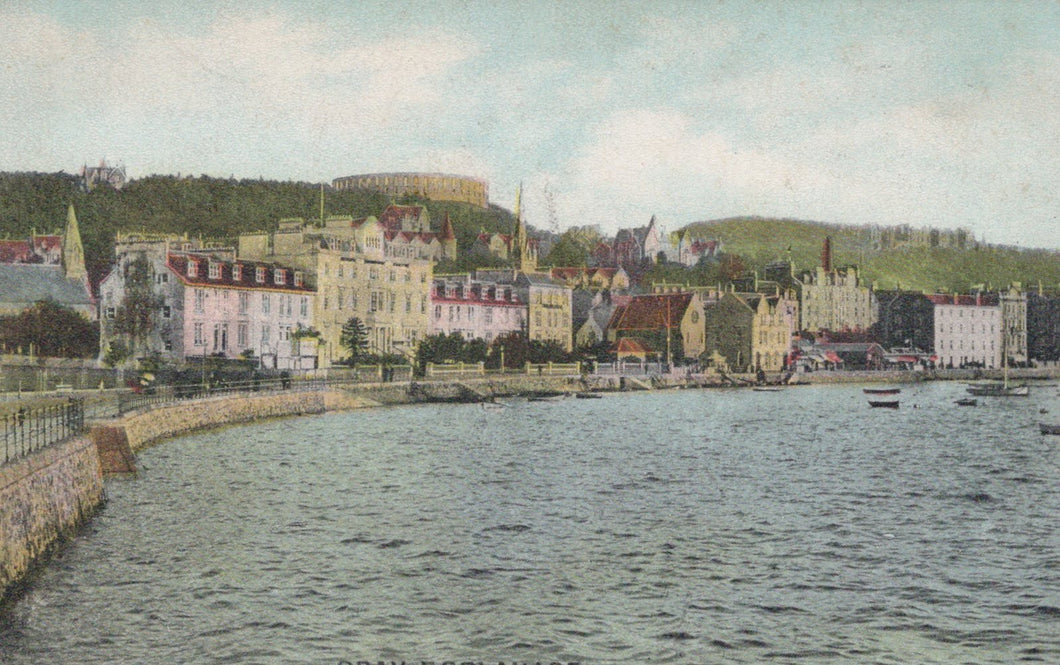 Vintage-style image of a coastal town with buildings and a body of water.