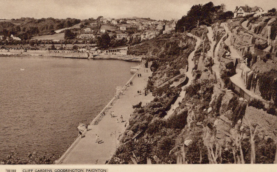 Vintage photograph of a coastal scene with a promenade and cliff gardens.