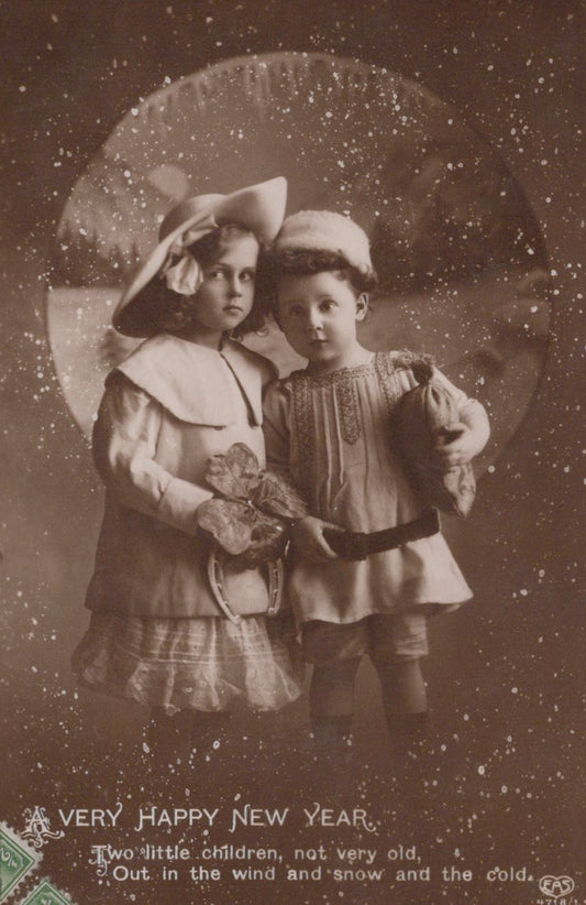Vintage photograph of two children in winter clothing with a decorative border and text.