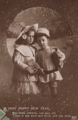 Vintage photograph of two children in winter clothing with a decorative border and text.