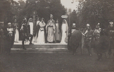 Stage performance with actors in formal attire outdoors