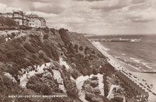 Load image into Gallery viewer, Vintage black and white photograph of a coastal scene with a zigzag path, houses, and a beach.
