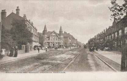 Vintage black and white photograph of a street scene with buildings and tram tracks in Birmingham.