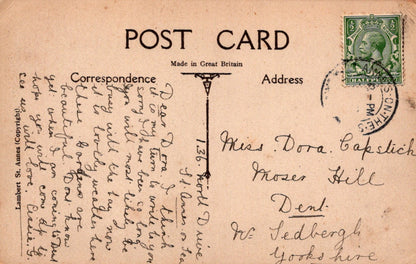 Vintage postcard with text and a stamp, featuring a green stamp on the top right corner.