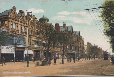 Vintage street scene with historical buildings and people on a city street.