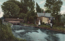 Load image into Gallery viewer, Vintage postcard of a canal scene with a houseboat and people by a wooden bridge.
