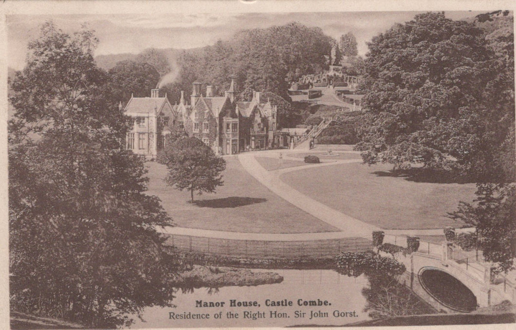 Manor house with a garden and trees in the background