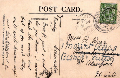 Vintage postcard with handwritten text and a stamp, featuring the word 'POSTCARD'.