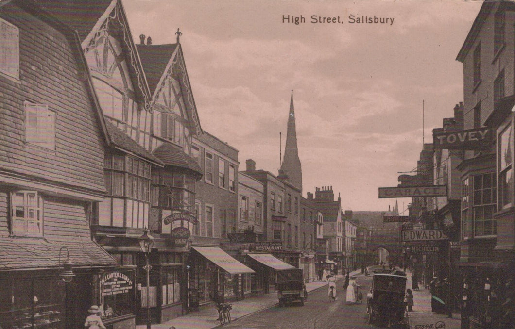 Vintage black and white photograph of High Street in Salisbury with historical buildings and street signs.