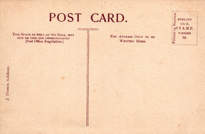 Back of a vintage postcard with text and stamps