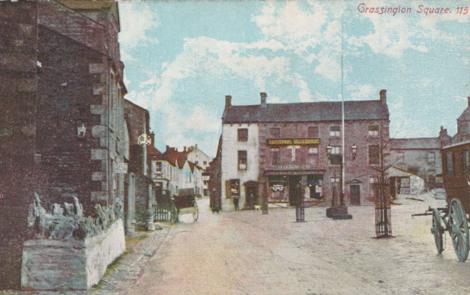 Vintage postcard of a street scene with buildings and a horse-drawn carriage.