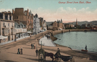 Vintage postcard of George Street from East, Oban, showing a waterfront scene with people and a horse-drawn carriage.