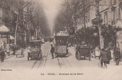 Vintage street scene in Nice with early automobiles and tram tracks