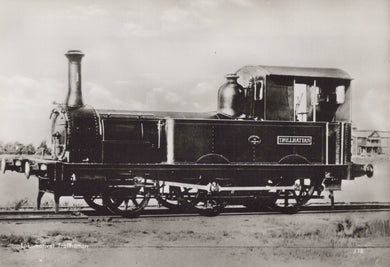 Vintage black and white photograph of a steam locomotive on a track.