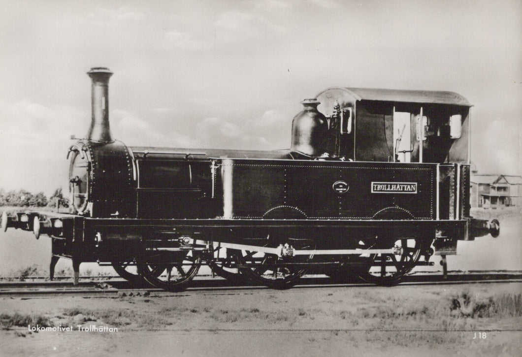 Vintage black and white photograph of a steam locomotive on a track.