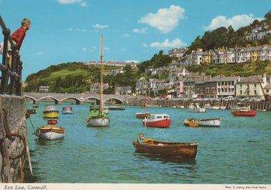 Harbor scene with boats and buildings in Cornwall, England.