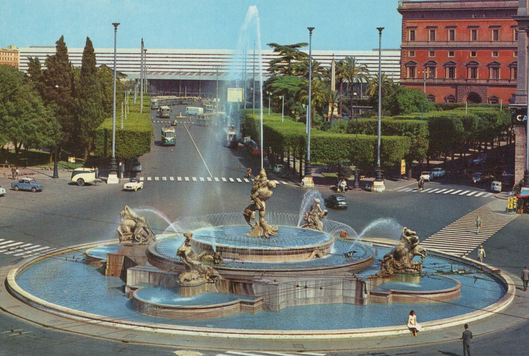 Large decorative fountain with water spouts in an urban setting