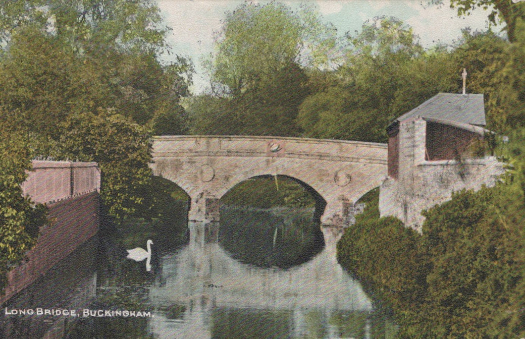 Vintage-style image of a stone bridge over water with trees and a building on the right.