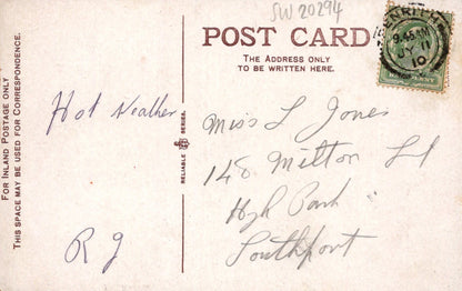 Vintage postcard with handwritten address and a stamp on a light brown background