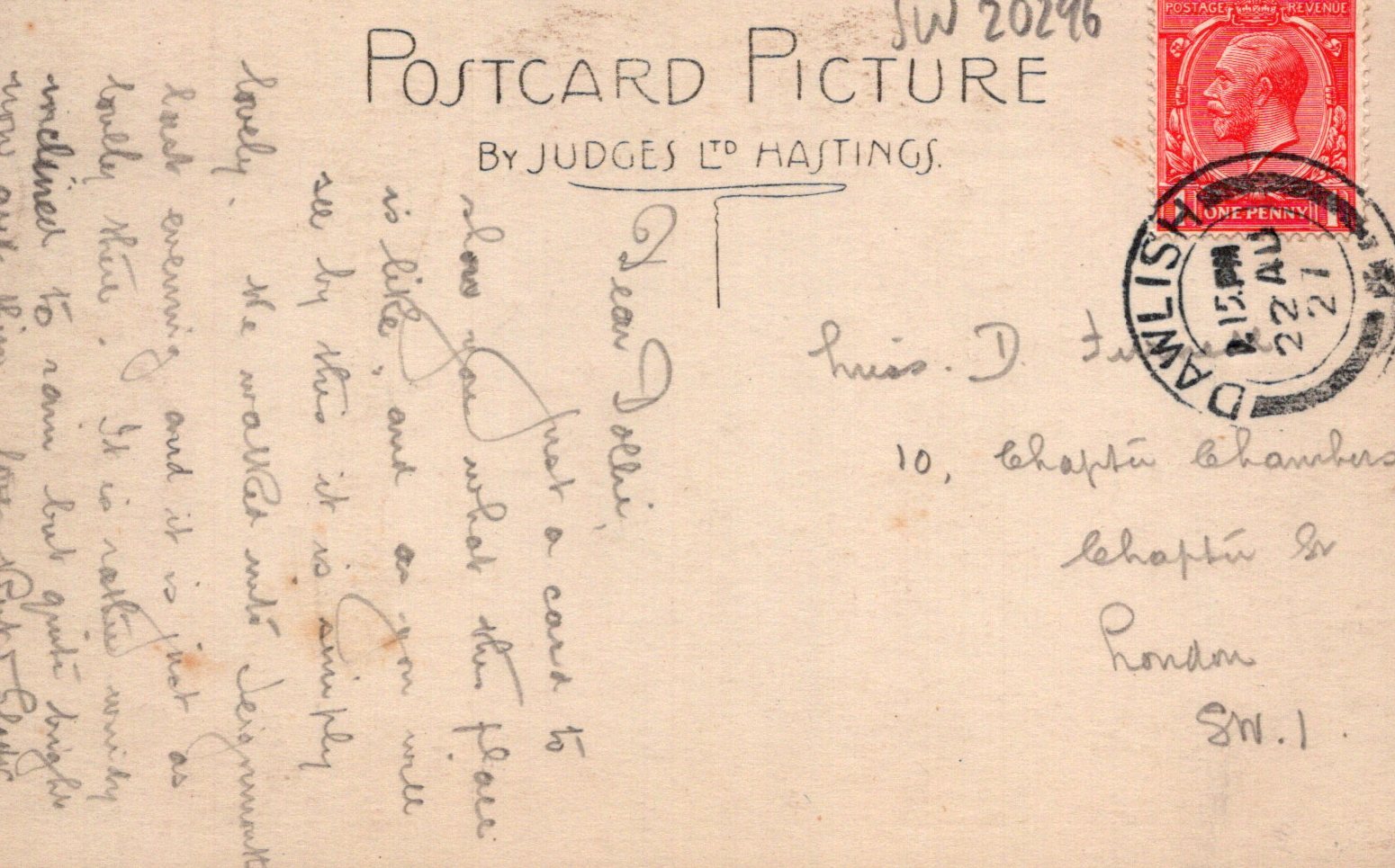 Vintage postcard with text, stamps, and a red stamp on a beige background