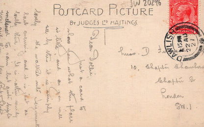 Vintage postcard with text, stamps, and a red stamp on a beige background