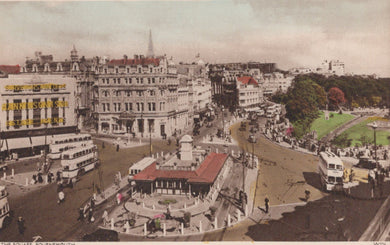 Vintage image of a city square with buildings, people, and vehicles.