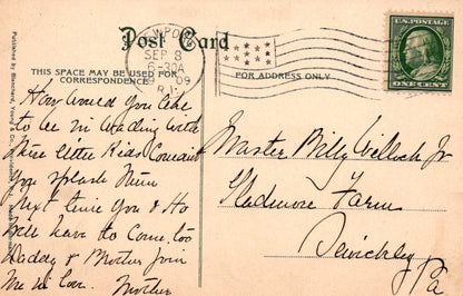 Vintage postcard with handwritten text and postage stamp, featuring a flag design.